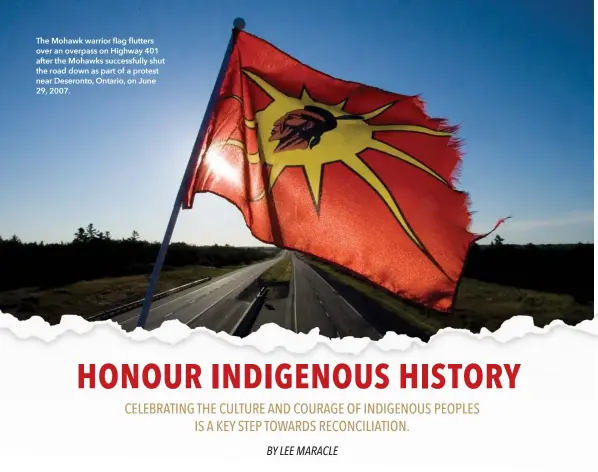  ??  ?? The Mohawk warrior flag flutters over an overpass on Highway 401 after the Mohawks successful­ly shut the road down as part of a protest near Deseronto, Ontario, on June 29, 2007.