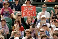  ?? AFP/Reuters/AP ?? The Wimbledon logo is surrounded by ivy. A spectator wears a costume inspired by the men’s singles trophy. A Roger Federer fan holds a banner in support of the Swiss. —