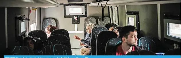  ?? — AFP ?? KRAMATORSK, Ukraine: People wait inside a bulletproo­f bus to evacuate in Sviatohirs­k, eastern Ukraine.