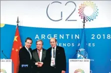  ?? XU JINGXING / CHINA DAILY ?? State Councilor and Foreign Minister Wang Yi, United Nations Secretary-General Antonio Guterres and French Foreign Minister Jean-Yves Le Drian face the media after their meeting to discuss climate change during the G20 Leaders’ Summit in Buenos Aires.