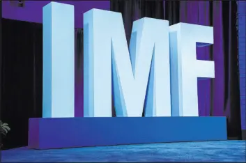  ?? Jacquelyn Martin The Associated Press ?? Letters spell out IMF during a news conference about the Internatio­nal Monetary Fund’s World Economic Outlook report Tuesday in Washington.