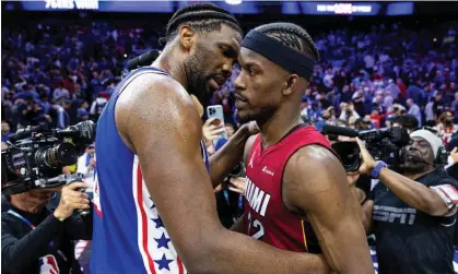  ?? Photograph: Bill Streicher/USA Today Sports ?? Joel Embiid hugs Miami Heat forward Jimmy Butler after the 76ers’ win on Wednesday night.