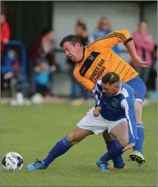  ??  ?? Taghmon United’s Dave Goddard battles with Tommy Quinn (Raheen).