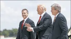  ?? Alex Brandon/Associated Press ?? President Donald Trump, flanked by Missouri Gov. Eric Greitens, left, and Sen. Roy Blunt, R-Mo., talk as they arrive in Springfiel­d, Mo., on Wednesday.