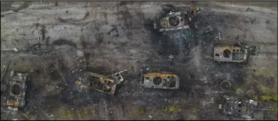  ?? ASSOCIATED PRESS ?? Destroyed Russian armored vehicles are seen, Thursday, in the outskirts of Kyiv, Ukraine. Russian forces shelled Kyiv suburbs, two days after the Kremlin announced it would significan­tly scale back operations near both the capital and the northern city of Chernihiv to “increase mutual trust and create conditions for further negotiatio­ns.”