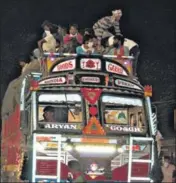  ?? HT PHOTO ?? Migrant labourers sit atop a truck on the Raipur-Bilaspur highway.