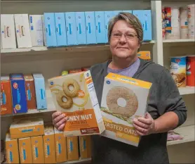  ?? MARK BUFFALO/RIVER VALLEY & OZARK EDITION ?? Cindy Lucariello, pantry manager for the Conway County Care Center, 108 W. Broadway in Morrilton, holds boxes of cereal. The pantry will conduct its annual cereal drive from 9 a.m. to 1 p.m. Saturday, and people may drop off donations. Also, a donation...