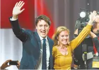  ?? AP-Yonhap ?? Liberal leader Justin Trudeau and wife Sophie Gregoire Trudeau wave as they go on stage at Liberal election headquarte­rs in Montreal, Monday.