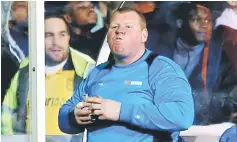  ?? — Reuters photo ?? Sutton United’s substitute Wayne Shaw eats a pie during the FA Cup match against Arsenal.