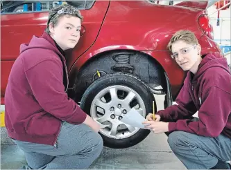  ?? KRIS DUBE SPECIAL TO THE WELLAND TRIBUNE ?? Saint Michael students Addison Kostuk and Jordan Gaubert checking the diameter of a tire at Niagara College's Rankin Technology Institute on Wednesday.