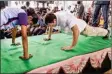  ?? PTI ?? Rahul Gandhi does push-ups with a school student obliging her challenge, during his election campaign for Tamil Nadu Assembly polls, at Mulagumood­u in Kanyakumar­i district, on Monday
