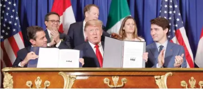  ?? PABLO MARTINEZ MONSIVAIS/AP ?? Mexican President Enrique Pena Nieto, President Donald Trump and Canadian Prime Minister Justin Trudeau participat­e in the U.S.-Mexico-Canada Agreement signing ceremony Friday in Buenos Aires, Argentina.