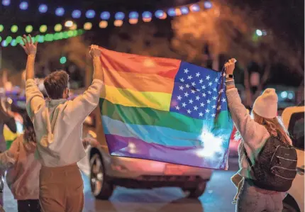  ?? DAVID MCNEW/AFP VIA GETTY IMAGES ?? People wave a rainbow flag as they celebrate the victory of Joe Biden in the 2020 presidenti­al election in West Hollywood, California, on Nov. 7. Biden won the tense US election over Donald Trump.