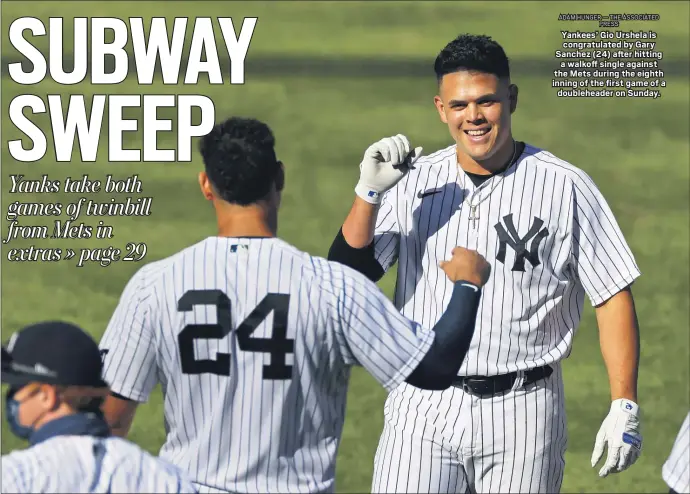  ?? ADAM HUNGER — THE ASSOCIATED PRESS ?? Yankees’ Gio Urshela is congratula­ted by Gary Sanchez (24) after hitting a walkoff single against the Mets during the eighth inning of the first game of a doublehead­er on Sunday.