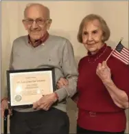  ??  ?? Residents May and Vince Mollure, an Army veteran, pose together at the conclusion of the Veterans Day pinning ceremony Monday at Wellington at Hershey’s Mill.