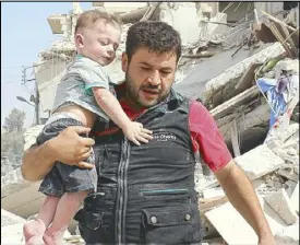  ?? AFP ?? A Syrian resident carries a baby after removing him from the rubble of a destroyed building following an air strike in Aleppo.
