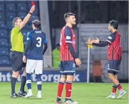  ??  ?? Marching orders: Elgin’s Rabin Omar, right, is shown a red card