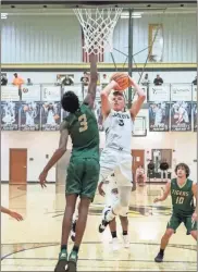  ?? Tim Godbee ?? Calhoun senior post Peyton Law puts up a shot with an Adairsvill­e defender in his face Wednesday at The Hive.