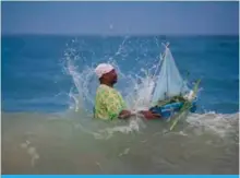  ??  ?? A worshipper takes a handmade boat into the sea as end-of-year offerings to Iemanja, the Goddess of the Sea of the Afro-Brazilian religion Umbanda, at Copacabana Beach in Rio de Janeiro, Brazil.