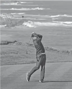  ?? TONY AVELAR/AP ?? Packers quarterbac­k Aaron Rodgers follows his drive from the fourth tee during last year’s AT&T Pebble Beach National Pro-Am.