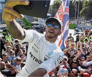  ?? — AP ?? Smile!: Mercedes driver Lewis Hamilton of Britain taking a selfie with fans after winning the Italian Grand Prix in Monza on Sunday.