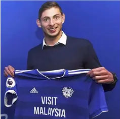  ??  ?? File photo released by Cardiff City FC via Noticias Argentinas taken on Jan 20 showing Sala posing with Cardiff’s jersey after signing for the club, in Cardiff, UK. — AFP photo