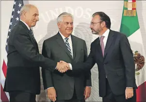  ?? AP PHOTO ?? U.S. Secretary of State Rex Tillerson (centre), smiles as Mexico’s Foreign Relations Secretary Luis Videgaray (right) shakes hands with U.S. Homeland Security Secretary John Kelly at the Foreign Affairs Ministry in Mexico City, Thursday.