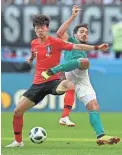  ??  ?? South Korea’s Lee Jae-sung, left, and Germany’s Mats Hummels fight for the ball.