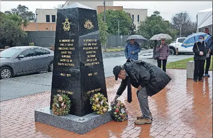  ?? ?? Paying respects: Mitchell Shire Mayor Bill Chisholm lays a wreath during the Vietnam Veterans’ Day commemorat­ions.