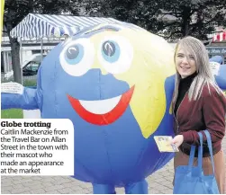  ??  ?? Globe trotting Caitlin Mackenzie from the Travel Bar on Allan Street in the town with their mascot who made an appearance at the market