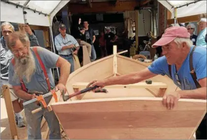  ?? PHOTO PROVIDED BY ELLIE BURHANS ?? Tom Russell, left, and John Kaufman, right, work on a prototype of the 12-foot Carolina bateau during the June 3 “practice build.” This was a preliminar­y training session for the featured attraction, the 1st Annual Hudson River Boat Building Challenge,...