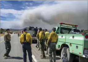  ?? ROBERTO E. ROSALES — ALBUQUERQU­E JOURNAL ?? Wildland firefighte­rs from several agencies throughout the country wait to be sent into the Hermits Peak and Calf Canyon Fires burning just west of Las Vegas, N.M.