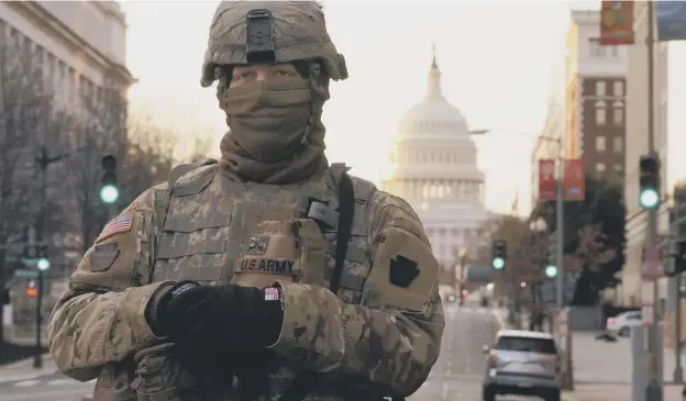  ??  ?? 0 A National Guardsman mans a security checkpoint near the US Capitol ahead of president-elect Joe Biden's inaugurati­on following the January 6 attack