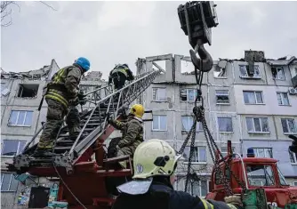  ?? Evgeniy Maloletka/Associated Press ?? Rescue workers clear the rubble of a residentia­l building destroyed Wednesday by a Russian rocket in Pokrovsk, Ukraine. Local authoritie­s say two people were killed and 12 injured.