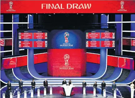  ?? MLADEN ANTONOV/AFP/GETTY IMAGES ?? The 2018 World Cup draw was unveiled at the State Kremlin Palace in Moscow on Friday with host Russia landing in Group A with Saudi Arabia, Egypt and Uruguay, while Group H is the only one without a former champ in Poland, Senegal, Colombia and Japan.