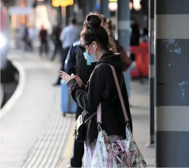  ??  ?? A face mask-clad passenger waits at Ipswich for an approachin­g service to London Liverpool Street on September 10. Paul Bigland reports a noticeable disparity in the levels of adherence to facemask rules and social distancing between different stations and operators.