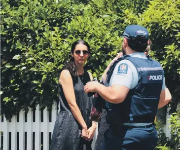  ?? DAVID WHITE/STUFF ?? Police speak to former MP Golriz Ghahraman outside her home in Grey Lynn.