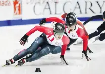  ?? JEFF MCINTOSH/THE CANADIAN PRESS ?? Charle Cournoyer, left, skates to 1,000-metre gold with Samuel Girard right behind him Sunday in Calgary.
