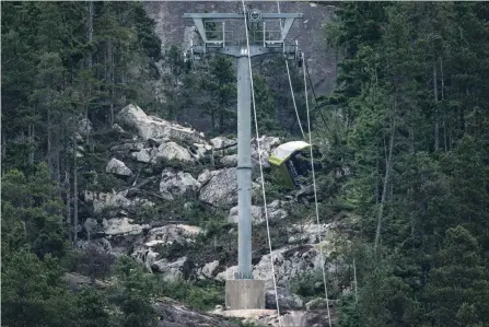  ?? DARRYL DYCK THE CANADIAN PRESS ?? A gondola car lies on its side on the mountain after a cable snapped at the Sea to Sky Gondola site in Squamish, B.C.