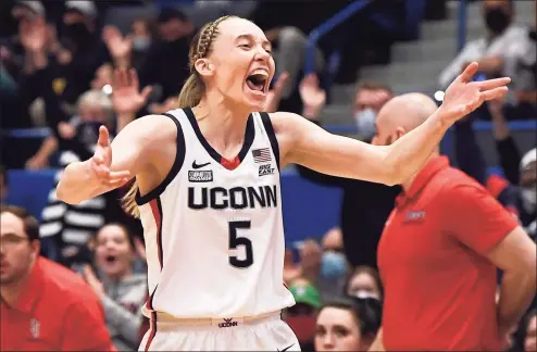  ?? Jessica Hill / Associated Press ?? UConn’s Paige Bueckers reacts after making her first basket after returning from injury in the first half against St. John’s on Friday night at XL Center in Hartford.