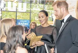  ?? NIKLAS HALLE’N/POOL VIA REUTERS ?? Britain’s Meghan, Duchess of Sussex, and Prince Harry, Duke of Sussex, chat with children of Disney executives as they arrive for the European premiere of the film “The Lion King” in London, Britain, last month
