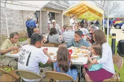  ??  ?? People eat brunch Sunday outside the Hindu Temple of Wisconsin during a fundraiser for victims of the Nepal earthquake.