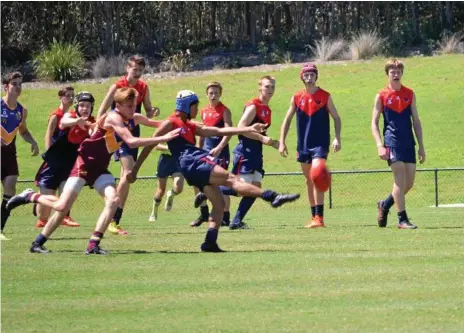  ?? Photo: Contribute­d ?? ON THE MOVE: Jonty MacDougall kicks forward for the Darling Downs Demons at the South Country Carnival U16 against Moreton Bay. He’s one of three Downs players chosen in the Lions Academy initial U18s squad.