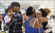  ?? CARLOS GIUSTI / ASSOCIATED PRESS ?? Waritza Alejandro embraces her mother-in-law, Maritza Ortiz, before boarding a flight to Tampa with her husband, Christian Vega, and their daughter, Tiana, in Carolina, Puerto Rico. The couple lost their home to Hurricane Maria.