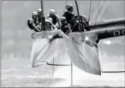  ?? ASSOCIATED PRESS ?? Emirates Team New Zealand (right) leads Oracle Team USA (left) during the fourth race of the America’s Cup competitio­n Sunday in Hamilton, Bermuda.