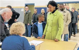  ?? Picture: REUTERS ?? UP FOR GRABS: US Democratic Congressio­nal candidate Jahana Hayes checks in to receive her ballot at a voting station in Wolcott, Connecticu­t, with her son, Myles