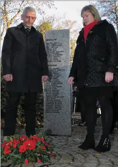  ??  ?? John Doran and Joyce Evans Kinsella laying a wreath during the Armistice commemorat­ion at Woodenbrid­ge War Memorial.