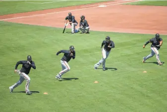  ?? Jessica Christian / The Chronicle ?? Giants players run drills during a summer session. The season was going to be challengin­g for manager Gabe Kapler even before the pandemic shortened it to 60 games.