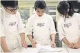  ??  ?? FINE ART: Three students from Culinary Arts Academy, Switzerlan­d, heat up the kitchens of Ecole Ritz Escoffier, Paris.