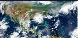  ?? ?? Above: NASA satellite image shows four hurricanes affecting North America simultaneo­usly on 15 September 2020; Katarina off Baja California, Sally above the Gulf of Mexico, Paulette near Bermuda and Teddy off the Leeward Islands, while wildfires rage from California to Colombia